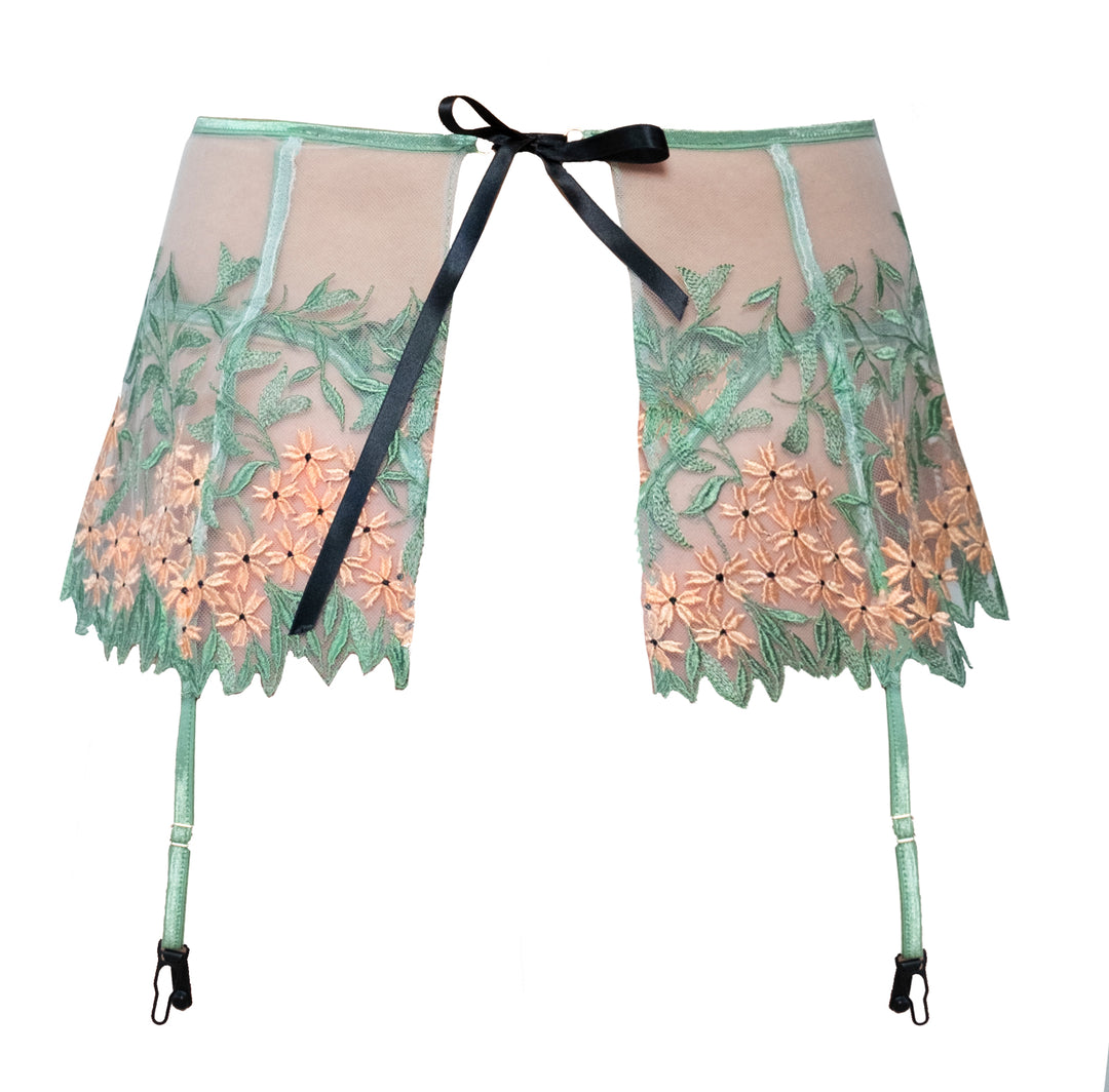 Green and Salmon Floral Embroidered Tulle Garter Belt is practically a flirty skirt; that's why Carol has nicknamed it the Skelt. Trimmed in shiny elastic, our Skelt is unlined and is fastened in the back with black satin ribbon.   Leg adjustable straps feature rose gold hardware and black clips.  For a set, match this style with our Grace Embroidered Tulle Underwire Bra and the Grace Embroidered Tulle Tanga.  A set made to drop any jaw. 