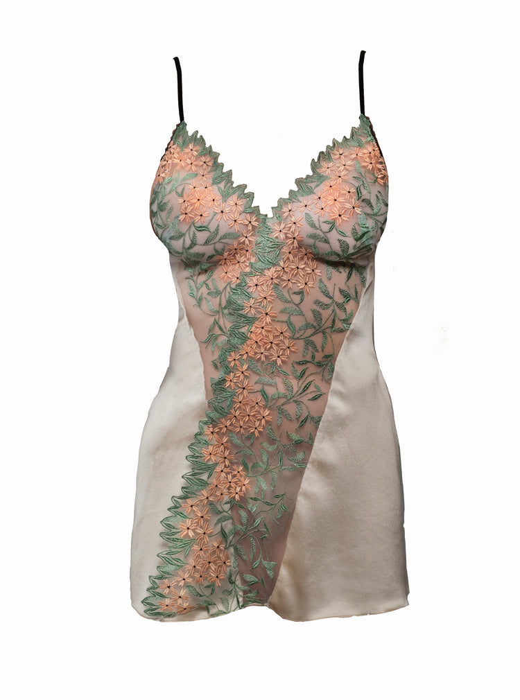 A breathtaking lush slip with front detail in green and salmon embroidered tulle. Designed with a diagonal seam for a flattering look. Features a contrasting lace detail and adjustable silk satin spaghetti straps.